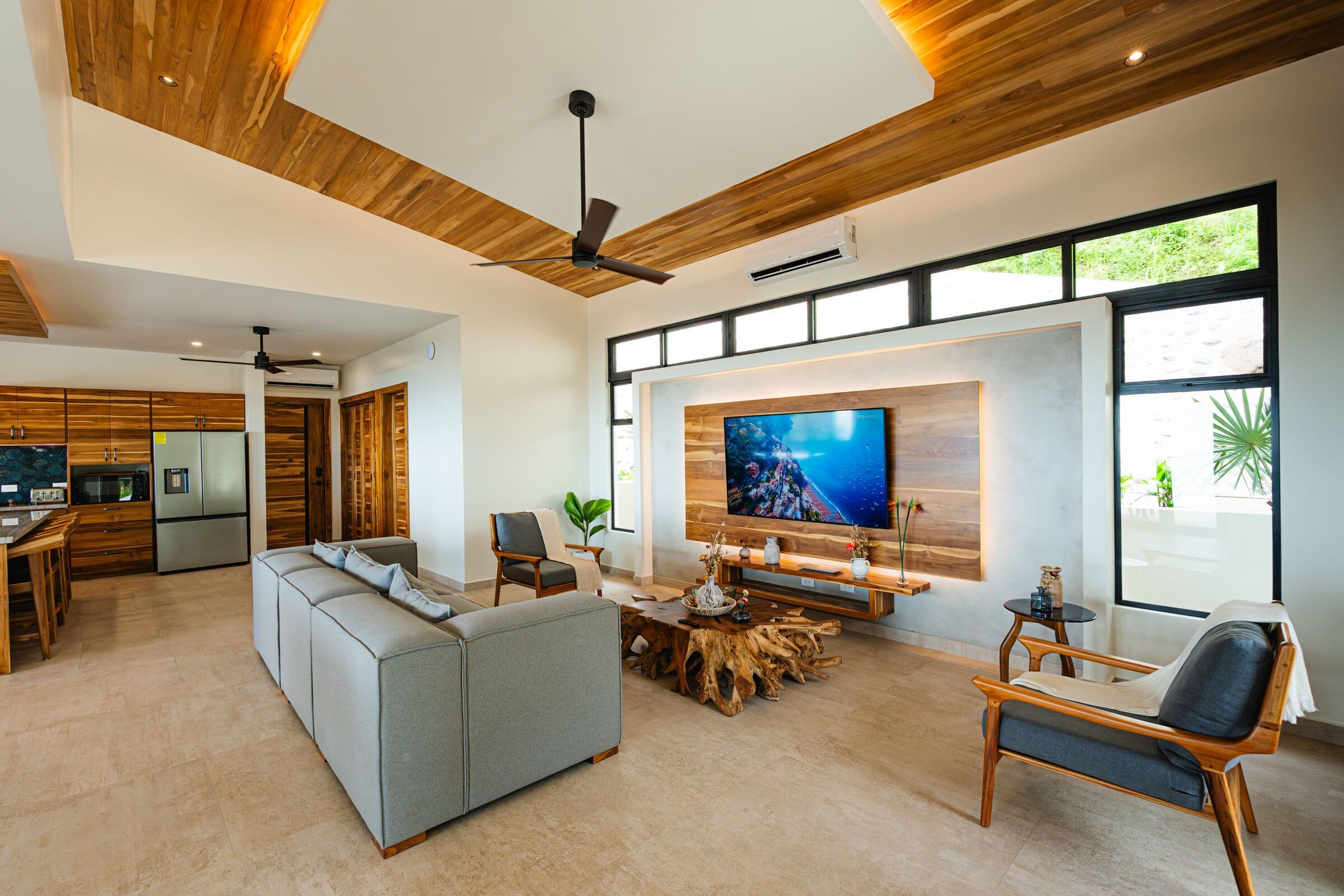 Living area with TV wall and teak root table