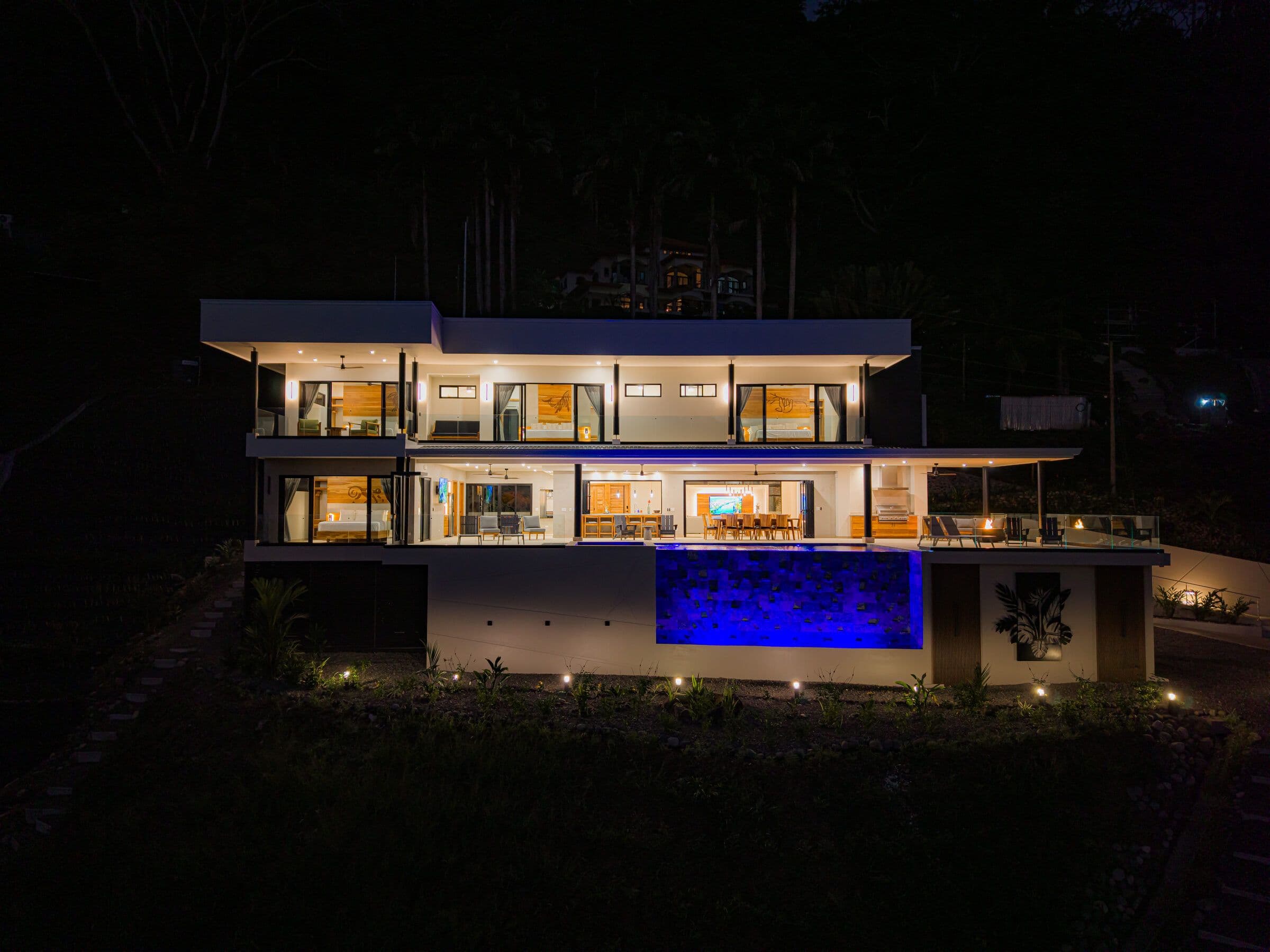 Night aerial with blue LED pool and lit facade