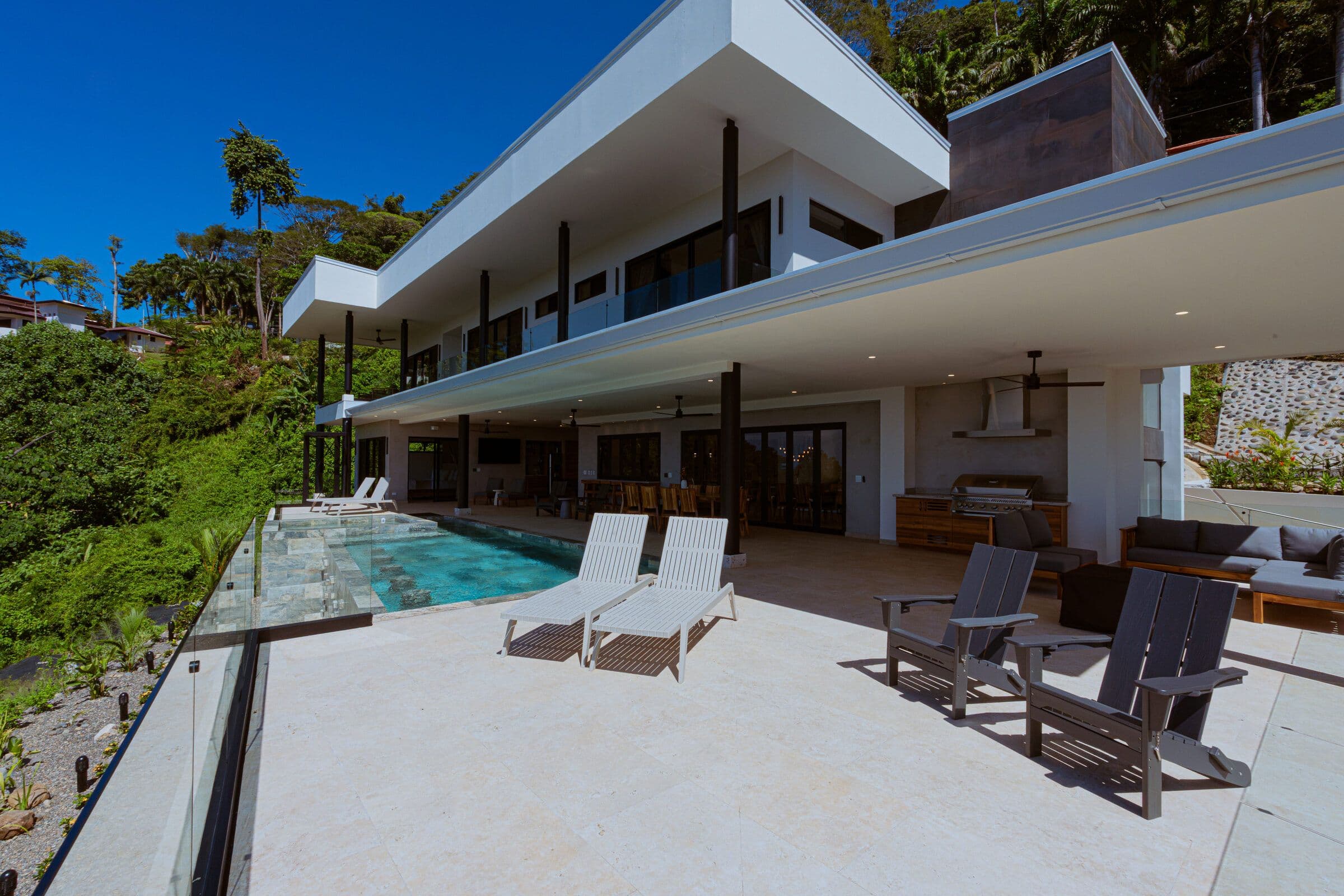 Full deck with pool, loungers, and BBQ area