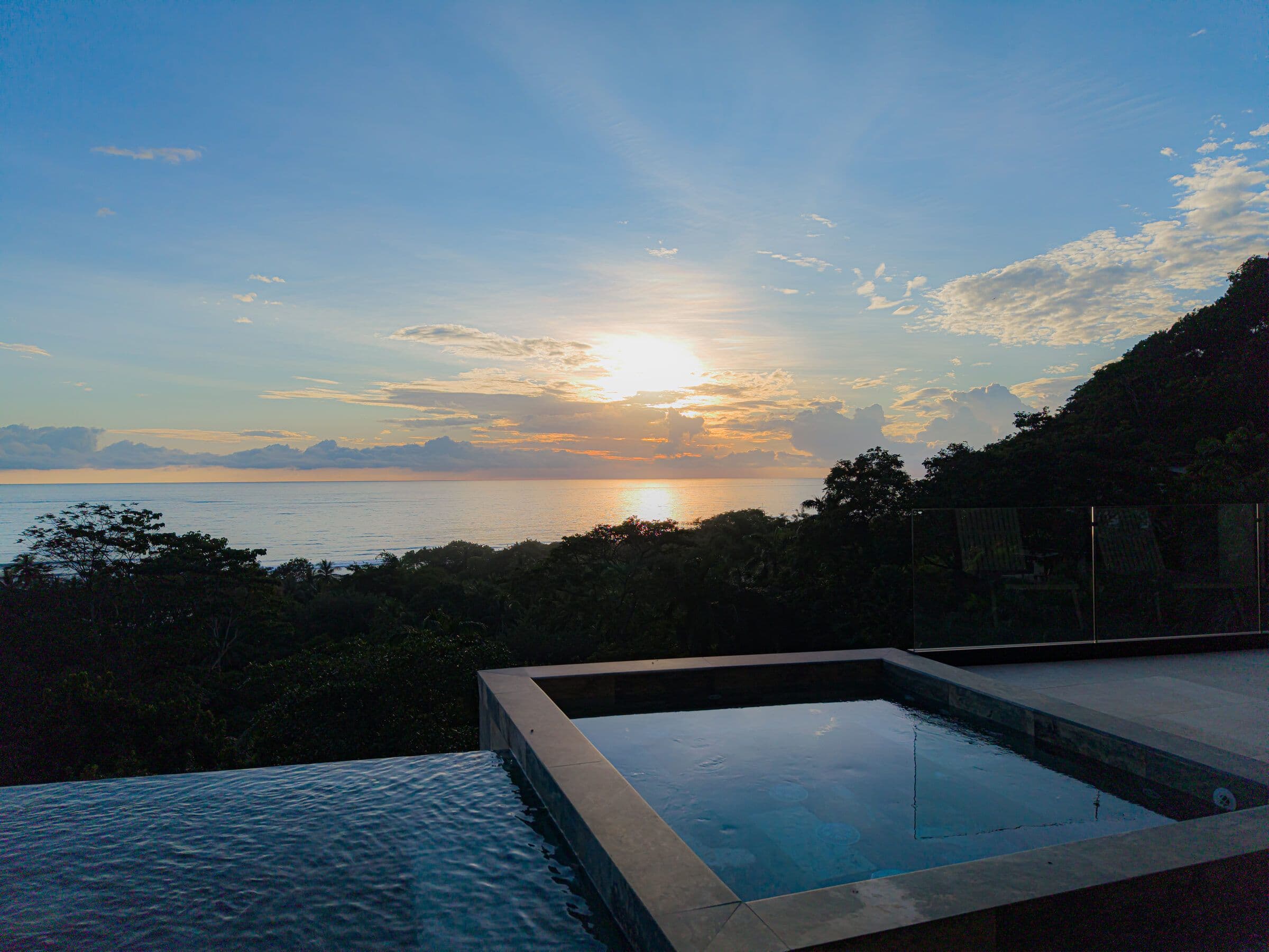 Jacuzzi and infinity pool at sunset with ocean view