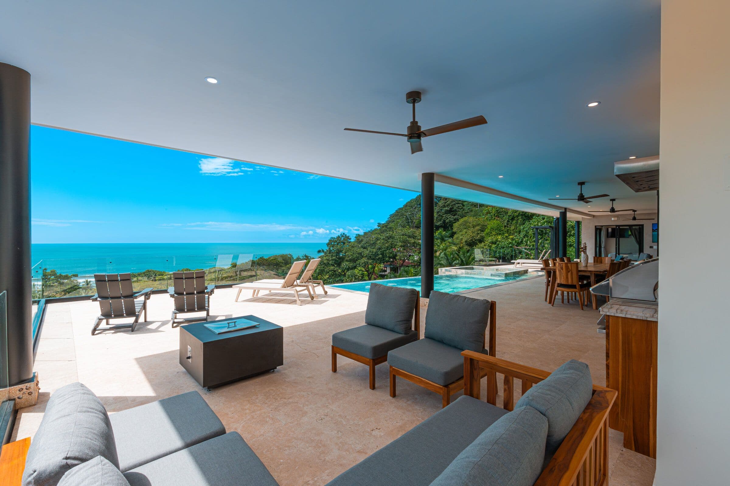 BBQ terrace with firepit, pool, and ocean view
